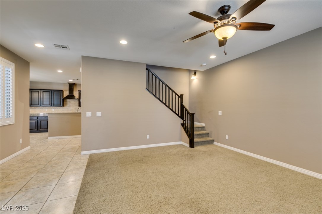 11063 Mt George Street Las Vegas, NV 89179 - Photo 4 of 49 Unfurnished living room featuring ceiling fan, sta