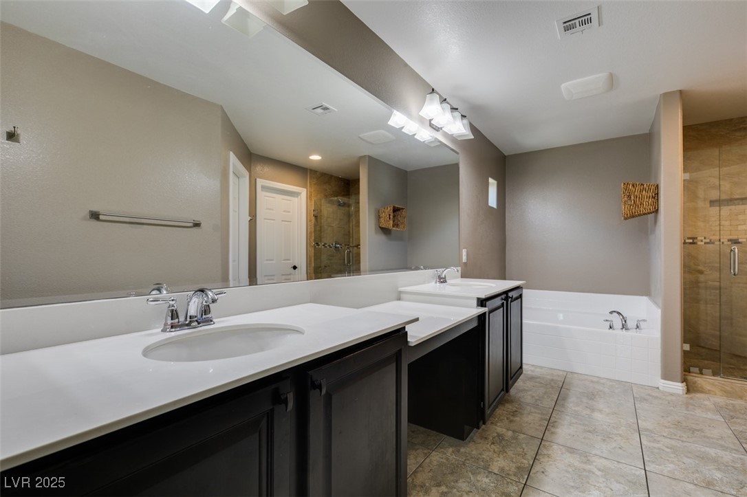 11063 Mt George Street Las Vegas, NV 89179 - Photo 41 of 49 Bathroom with a shower stall, vanity, a bath, and