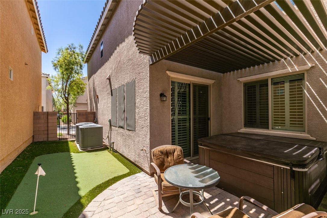 11063 Mt George Street Las Vegas, NV 89179 - Photo 43 of 49 View of patio featuring a hot tub and a putting gr