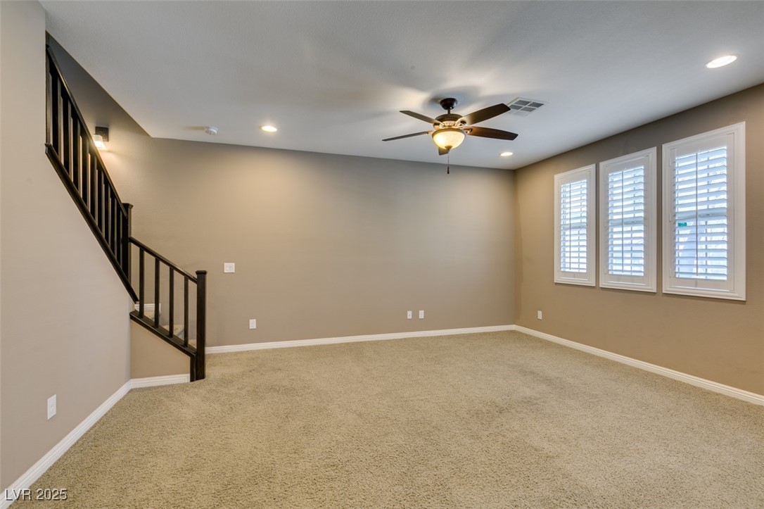 11063 Mt George Street Las Vegas, NV 89179 - Photo 6 of 49 Carpeted spare room with ceiling fan, stairs, and