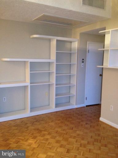 1851 Columbia Road Northwest, Unit 608 Washington, DC 20009 - Photo 13 of 16 a view of an empty room with empty shelves
