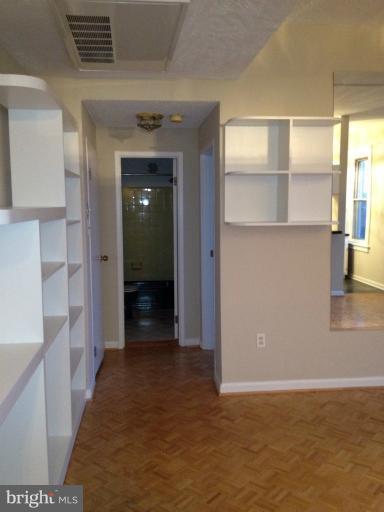 1851 Columbia Road Northwest, Unit 608 Washington, DC 20009 - Photo 7 of 16 a view of a hallway with wooden shelves