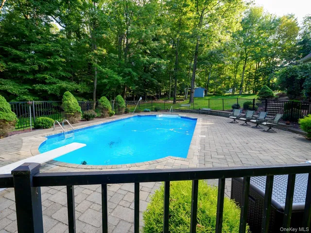 a front view of a house with yard and green space