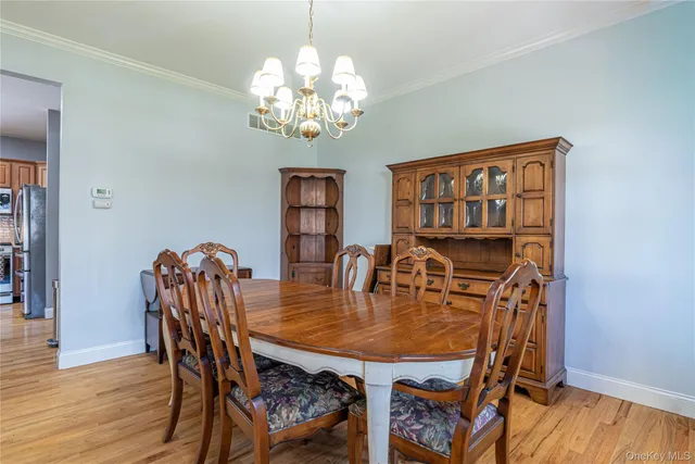 a view of a dining room with furniture wooden floor and chandelier