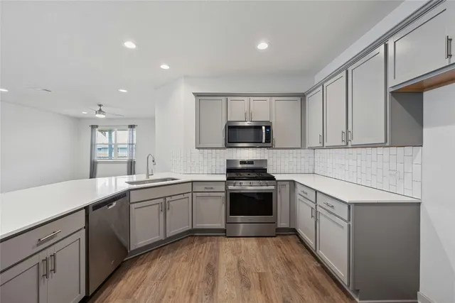 a kitchen with a sink stove and microwave