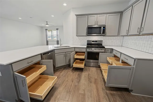 a view of a kitchen and wooden floor