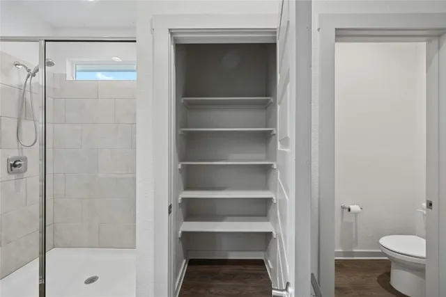 a bathroom that has a glass shower door