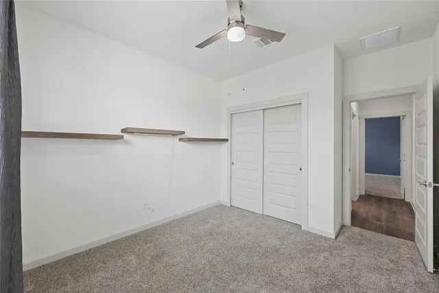 a bedroom with a bed window and table