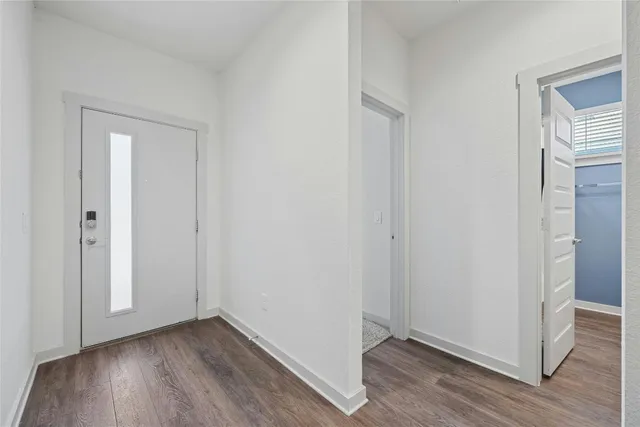 a view of a kitchen with cabinets and wooden floor