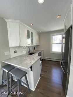 52 Prospect Street, Unit 2 Greenwich, CT 06830 - Photo 11 of 17 a kitchen with a stove a sink and a refrigerator