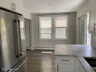 52 Prospect Street, Unit 2 Greenwich, CT 06830 - Photo 12 of 17 a view of a refrigerator a window and wooden floor