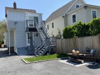 52 Prospect Street, Unit 2 Greenwich, CT 06830 - Photo 16 of 17 a wooden bench sitting in front of a house