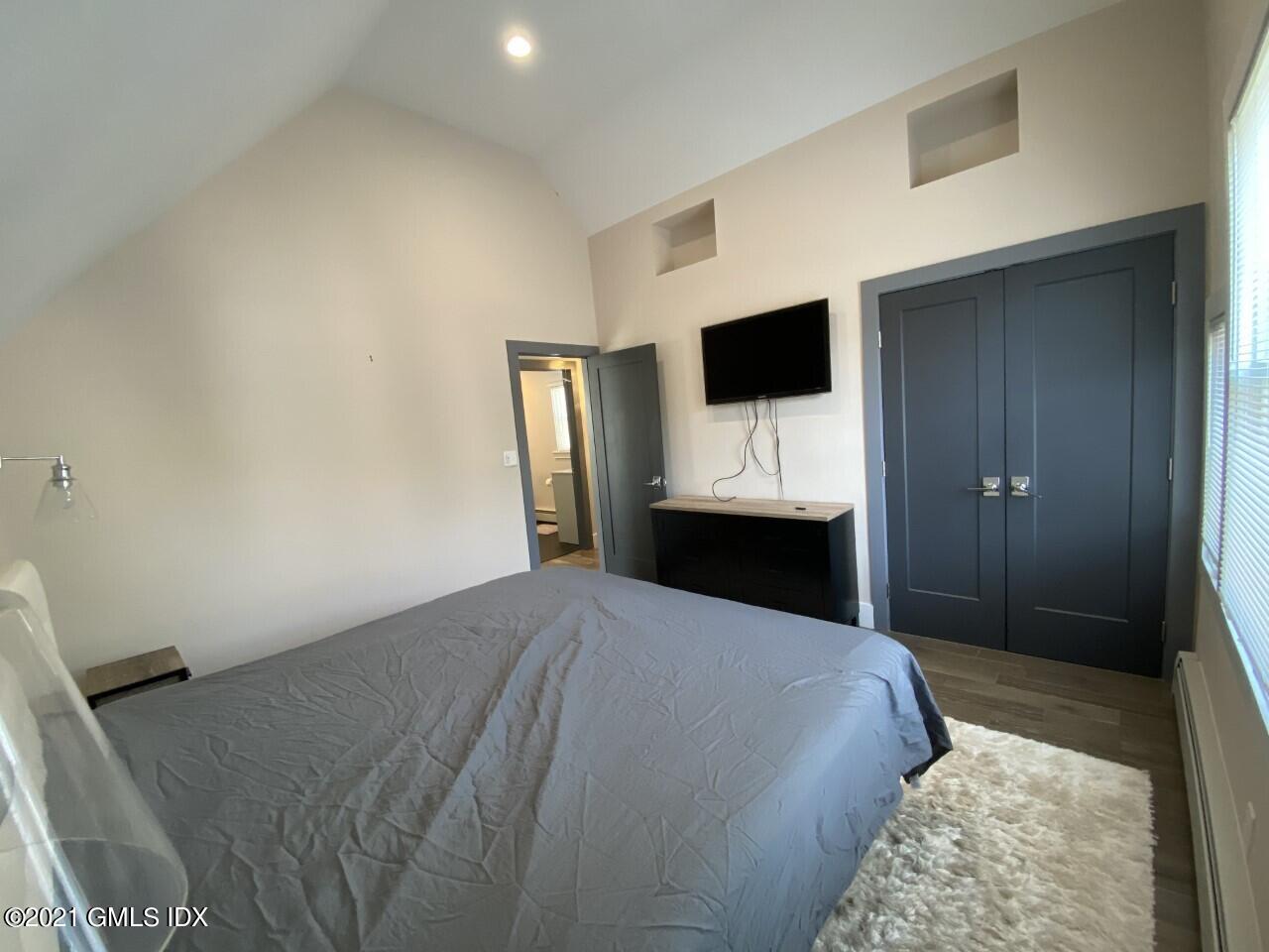 52 Prospect Street, Unit 2 Greenwich, CT 06830 - Photo 6 of 17 a bedroom with a bed and a television