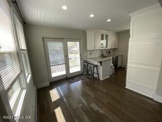 52 Prospect Street, Unit 2 Greenwich, CT 06830 - Photo 10 of 17 a view of a kitchen with furniture and a floor to ceiling window