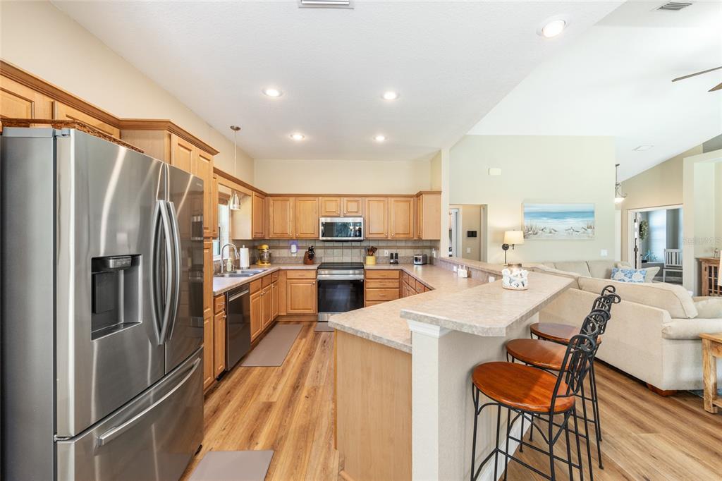 19639 Southwest 77th Loop Dunnellon, FL 34432 - Photo 26 of 59 a kitchen with white cabinets and stainless steel appliances