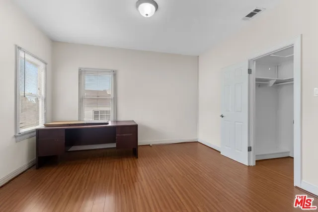 a room with window and hardwood floor