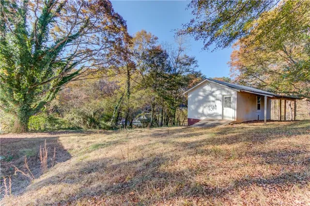 a view of a house with a yard and garage