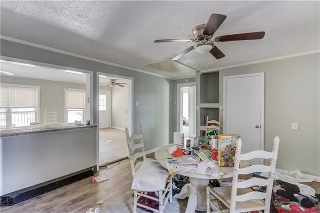 a view of a dining room with furniture and a large window