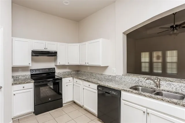 a kitchen with granite countertop cabinets and steel stainless steel appliances