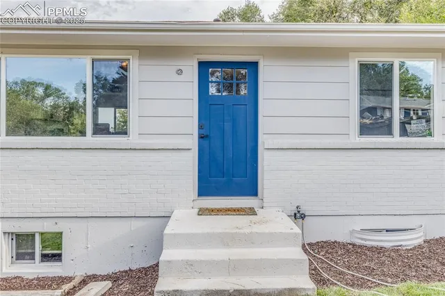 a bathroom with a toilet and a window