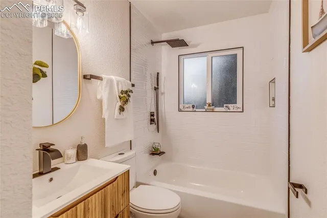 a bathroom with a sink a mirror a vanity and a shower