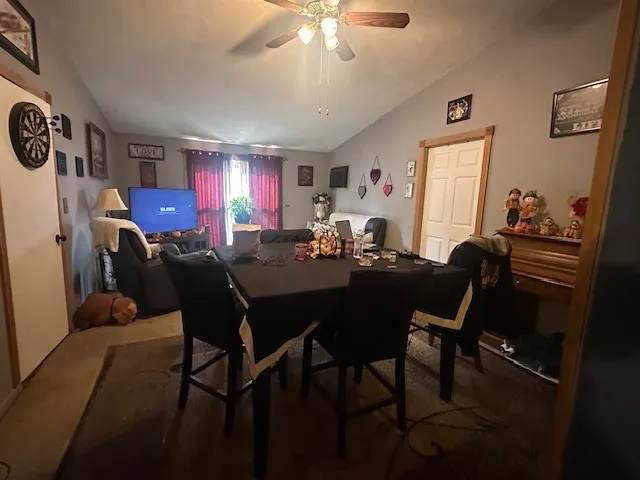 a view of a dining room with furniture and chandelier
