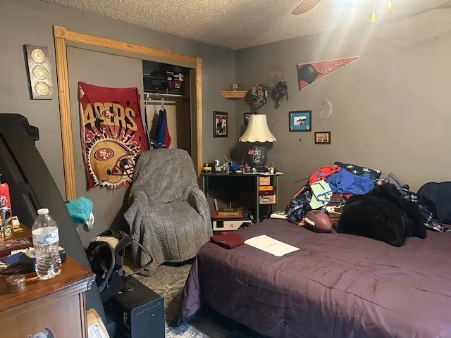 a bedroom with bed and a mirror