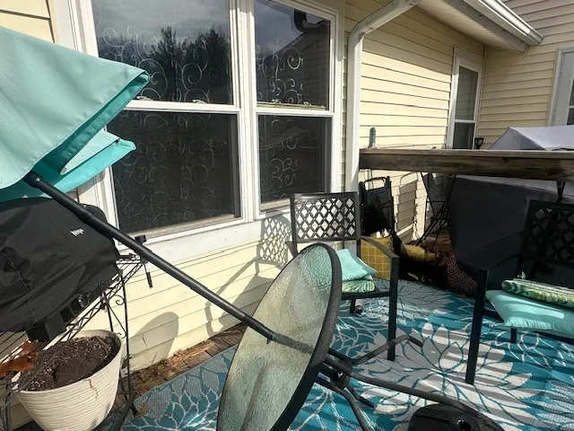a view of a chairs and table in the balcony