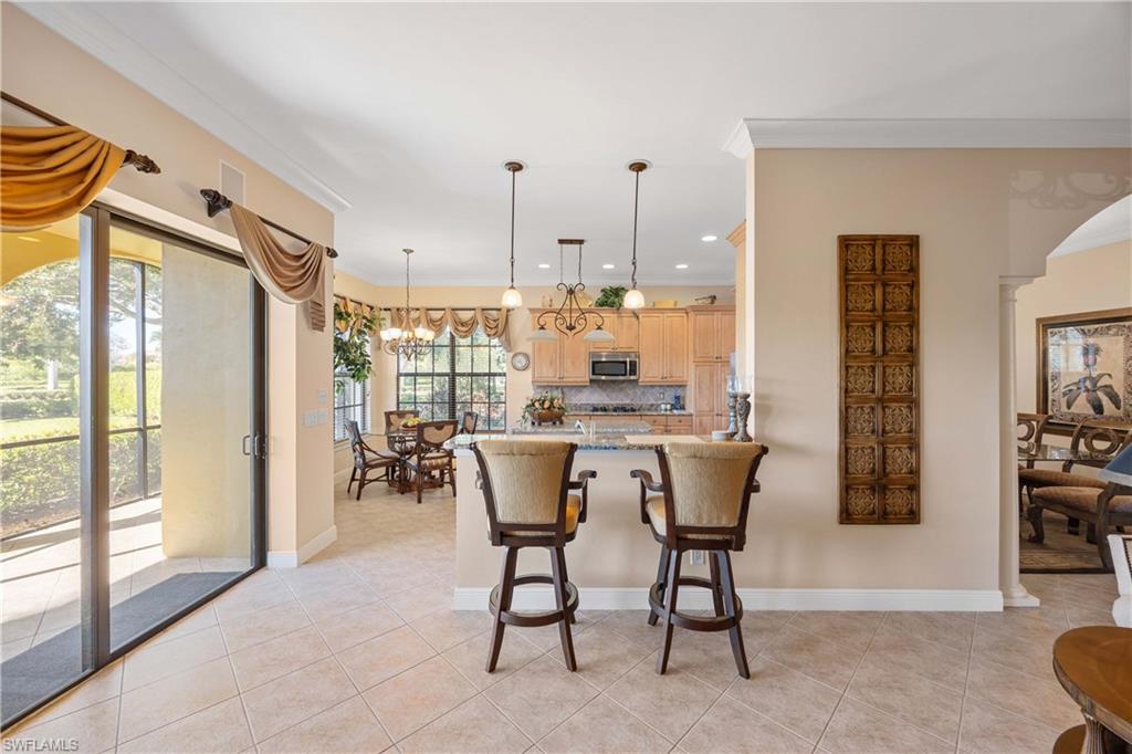 9105 Prima Way, Unit 102 Naples, FL 34113 - Photo 12 of 49 a dining room with furniture and window