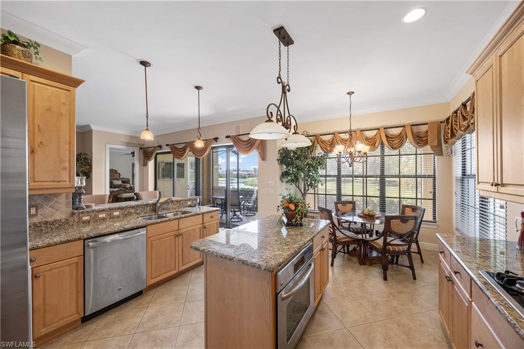 9105 Prima Way, Unit 102 Naples, FL 34113 - Photo 14 of 49 a open kitchen with stainless steel appliances granite countertop a sink and stove