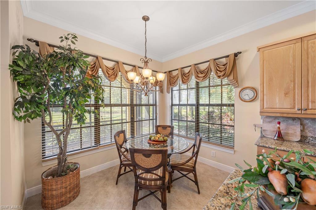 9105 Prima Way, Unit 102 Naples, FL 34113 - Photo 15 of 49 a dining room with furniture and window