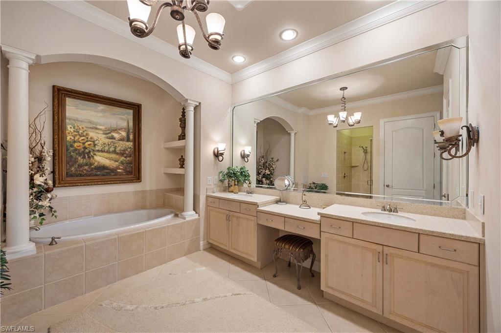 9105 Prima Way, Unit 102 Naples, FL 34113 - Photo 20 of 49 a spacious bathroom with a bathtub a sink and a mirror