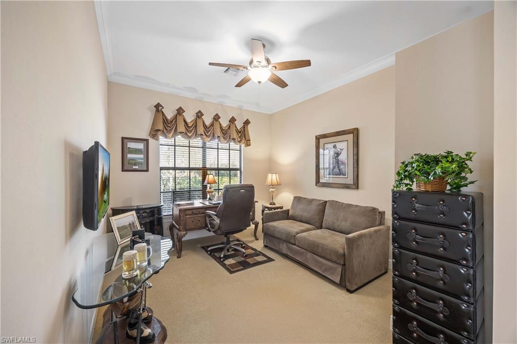 9105 Prima Way, Unit 102 Naples, FL 34113 - Photo 22 of 49 a living room with furniture a chandelier and a window