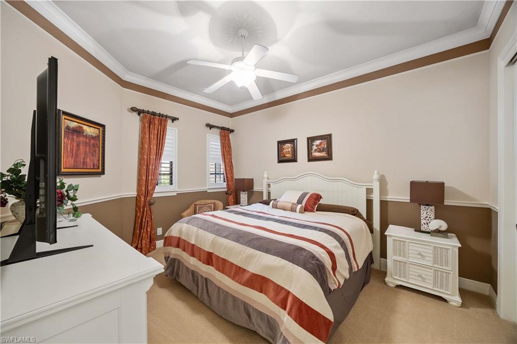 9105 Prima Way, Unit 102 Naples, FL 34113 - Photo 24 of 49 a bedroom with a bed and a flat screen tv