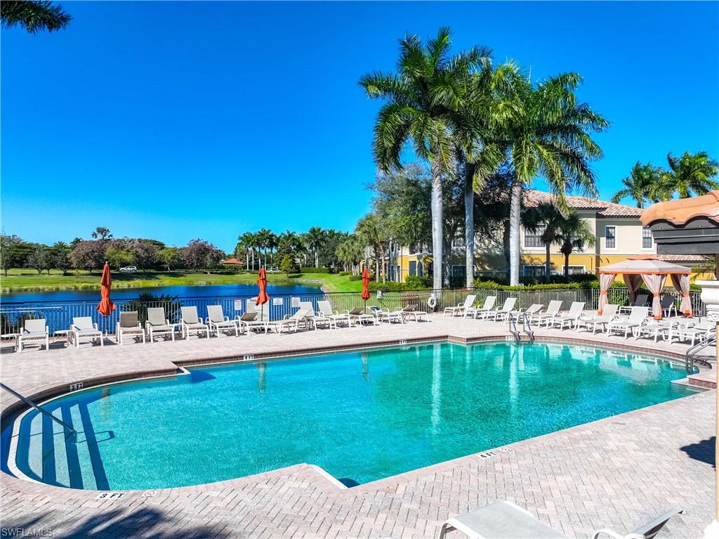 9105 Prima Way, Unit 102 Naples, FL 34113 - Photo 32 of 49 a view of a swimming pool with a patio