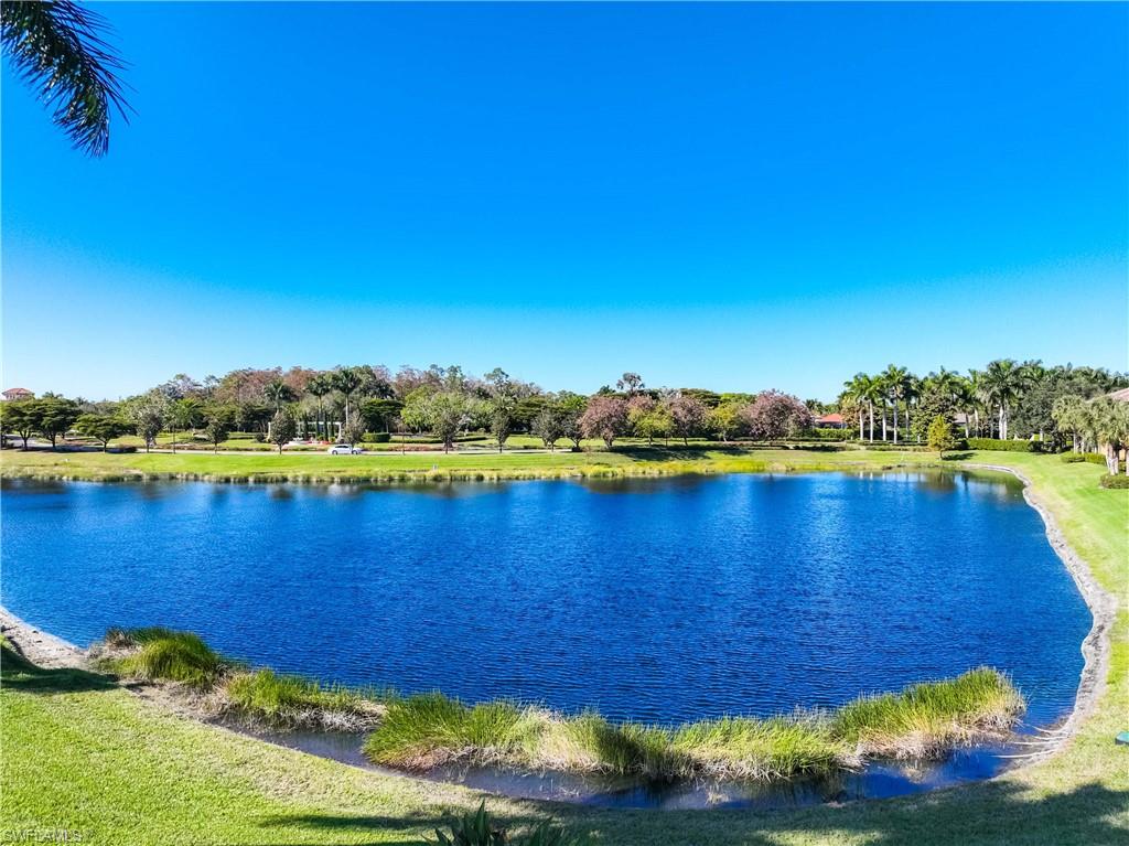 9105 Prima Way, Unit 102 Naples, FL 34113 - Photo 33 of 49 a view of a lake with houses