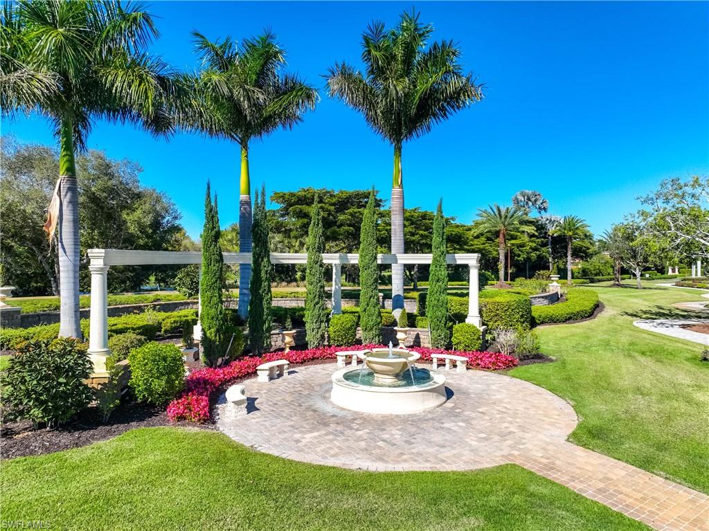 9105 Prima Way, Unit 102 Naples, FL 34113 - Photo 37 of 49 a view of a backyard with a garden and plants