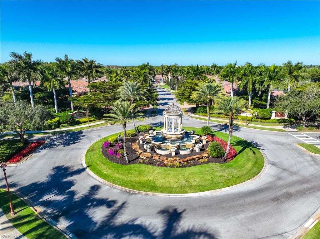9105 Prima Way, Unit 102 Naples, FL 34113 - Photo 41 of 49 a view of a swimming pool with a yard and lake view