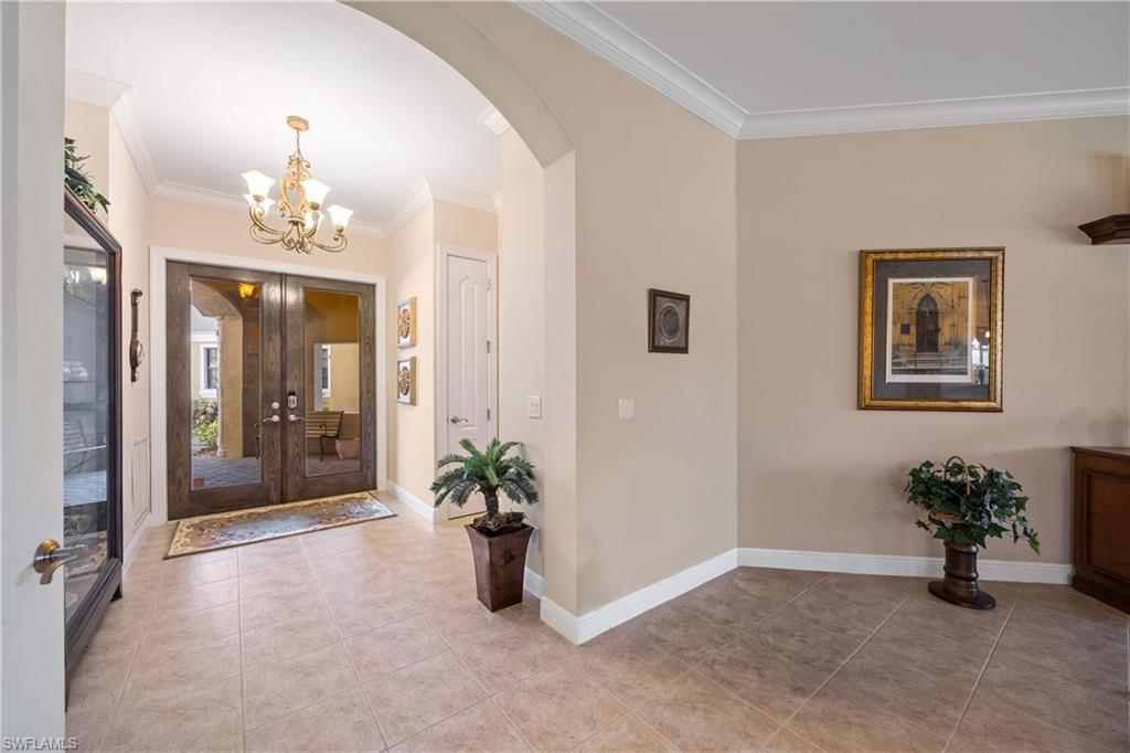 9105 Prima Way, Unit 102 Naples, FL 34113 - Photo 7 of 49 wooden floor in an empty room with a mirror