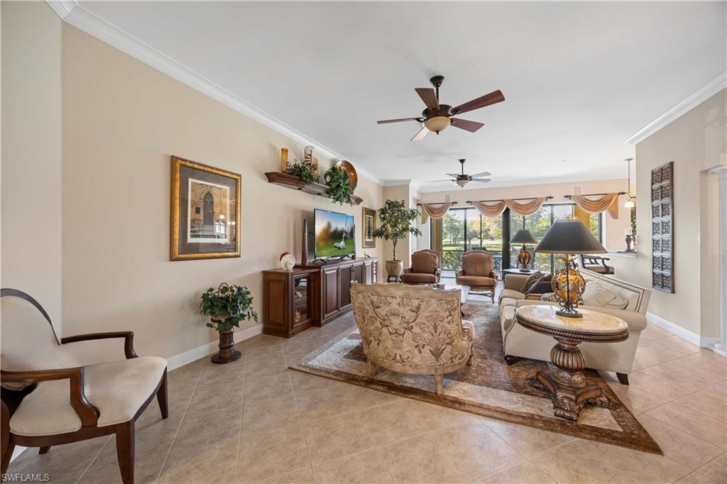 9105 Prima Way, Unit 102 Naples, FL 34113 - Photo 8 of 49 a living room with furniture and a floor to ceiling window