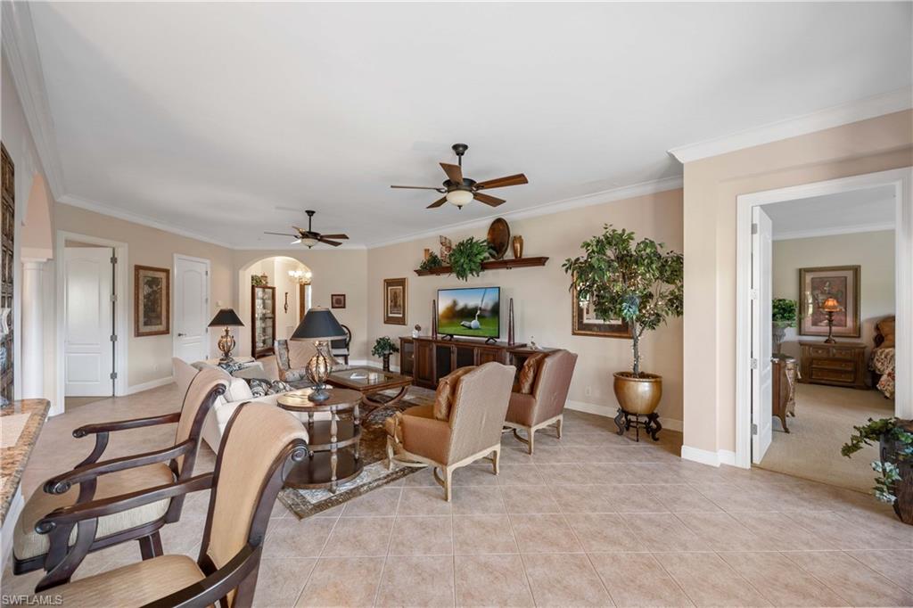 9105 Prima Way, Unit 102 Naples, FL 34113 - Photo 10 of 49 a living room with furniture and a chandelier
