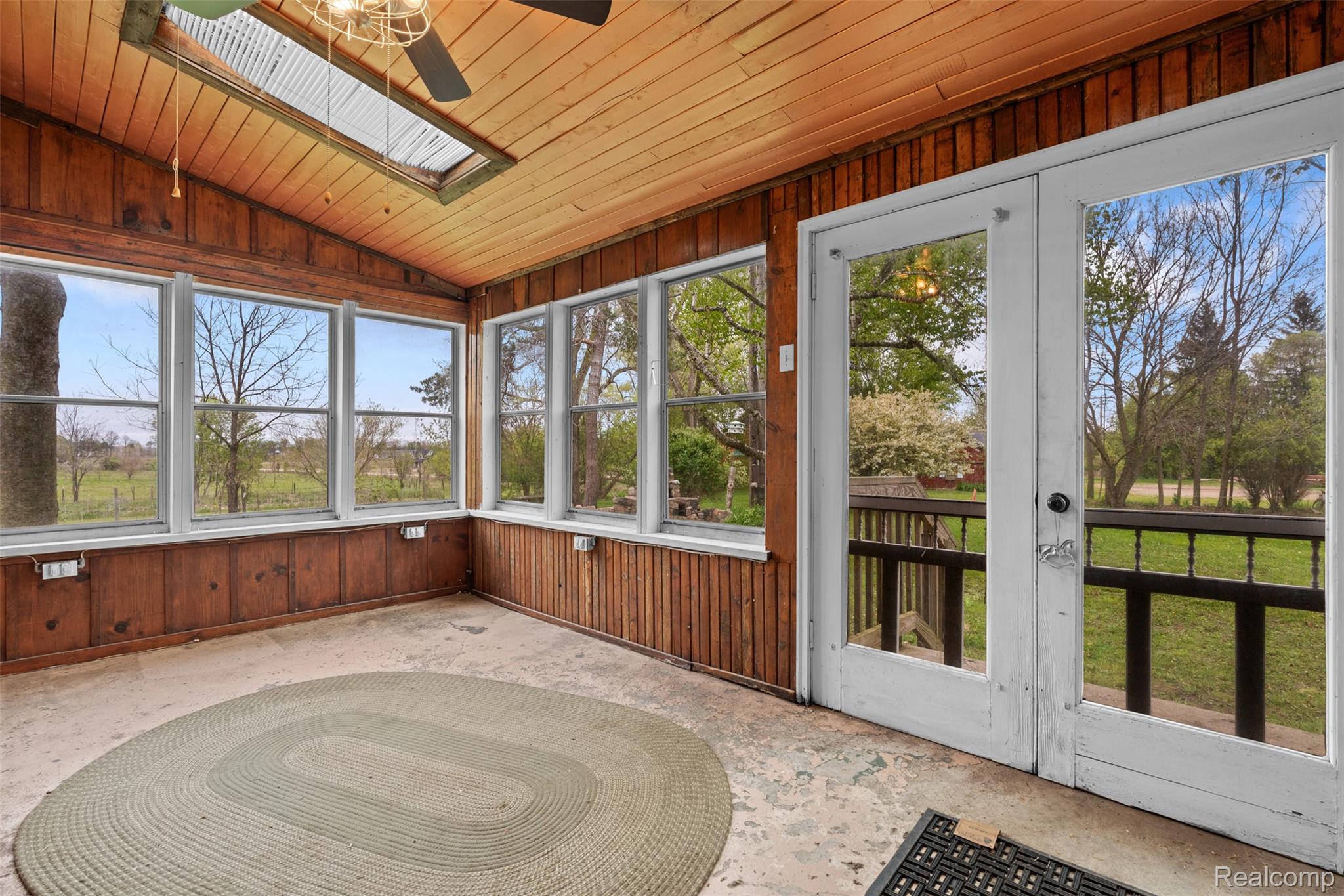 1775 Imlay City Road Lapeer, MI 48446 - Photo 24 of 60 Unfurnished sunroom featuring wooden walls, a vaulted wooden ceiling, french doors, healthy amount of natural light, and a skylight