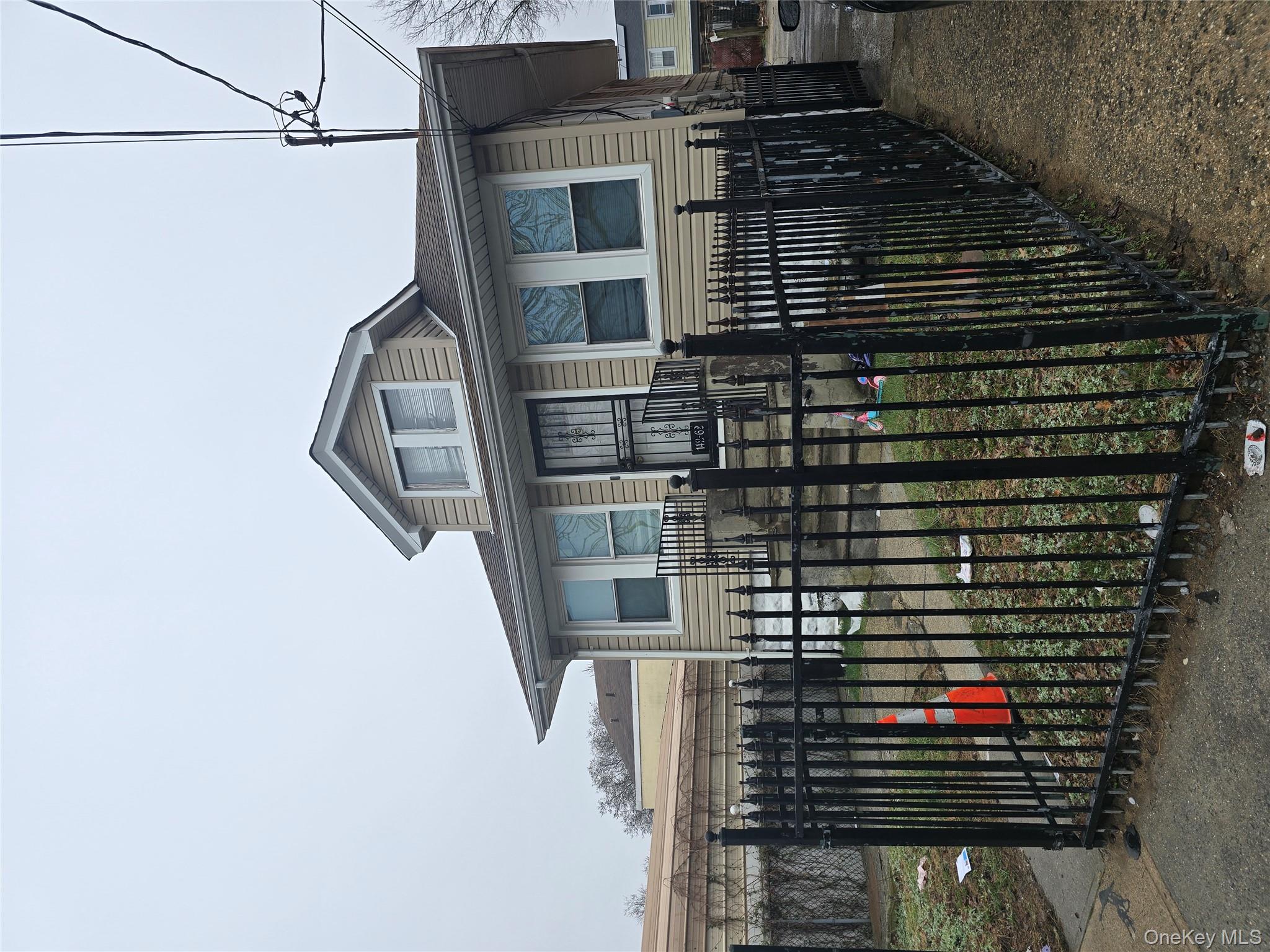 a view of a house with wooden fence