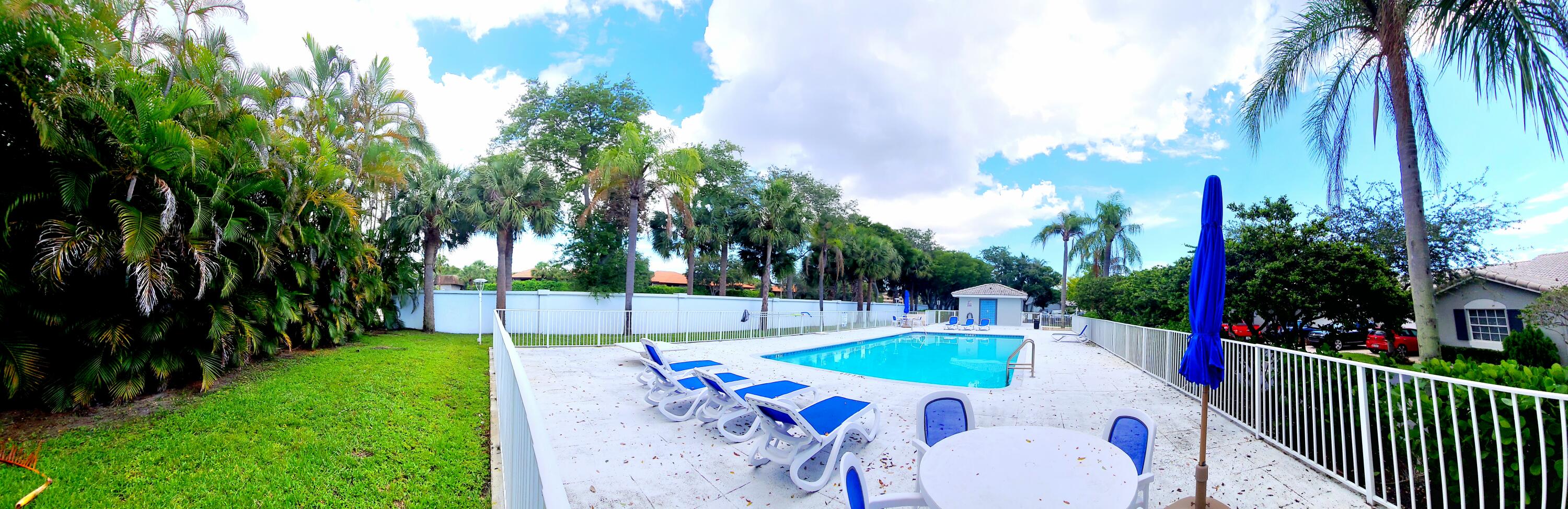 5121 Sabal Gardens Lane, Unit 2 Boca Raton, FL 33487 - Photo 25 of 25 a view of a backyard with swimming pool and furniture