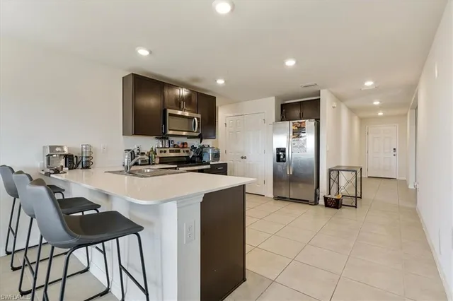 a kitchen with a sink and a stove top oven with wooden floor