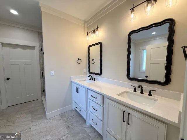 a bathroom with double vanity sinks and two mirror