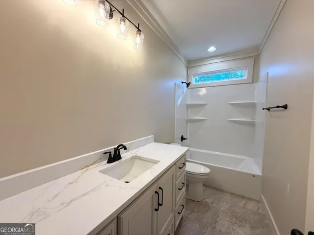 a bathroom with a sink vanity mirror and toilet