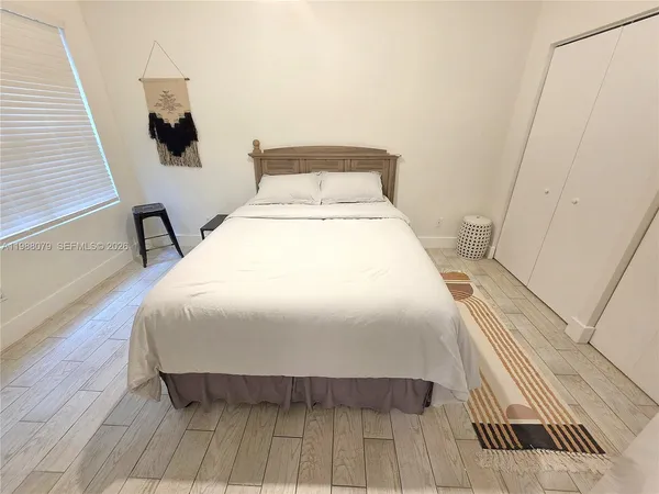 a bed sitting in a bedroom next to a window