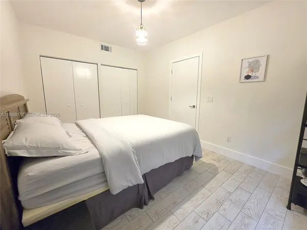 a bedroom with a bed and a mirror