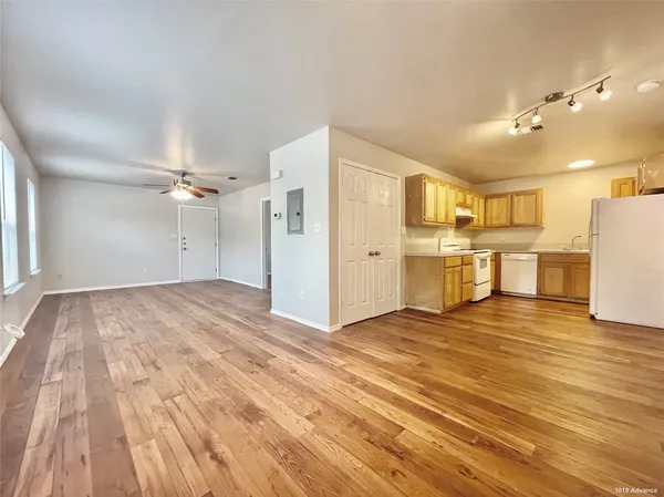 a view of a kitchen with a dishwasher cabinets and wooden floor